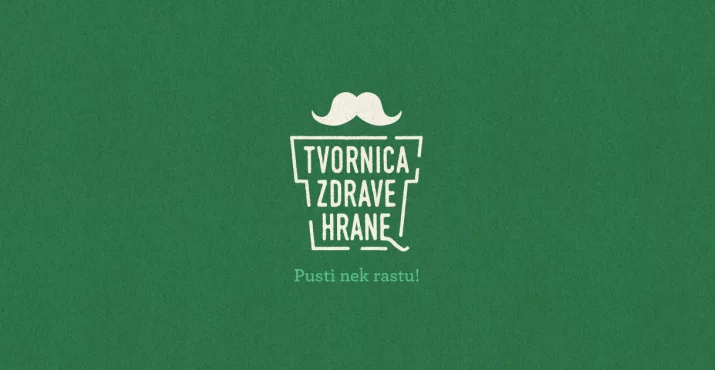 Stilizirani logo Tvornice Zdrave Hrane s brkovima na zelenoj pozadini